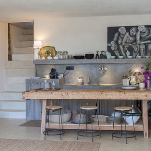 Photo of a mid-sized industrial single-wall open plan kitchen in Catania-Palermo with open cabinets, grey cabinets, concrete benchtops and grey splashback.