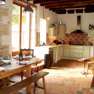 Large farmhouse l-shaped open plan kitchen in Angers with ceramic splashback, terracotta flooring, orange floors, beige worktops, a submerged sink, beaded cabinets, beige cabinets and multi-coloured splashback.