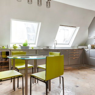 Idées déco pour une grand cuisine américaine contemporaine en L avec un placard à porte plane, des portes de placard grises et un plan de travail en inox.