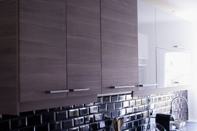 This is an example of a small contemporary single-wall enclosed kitchen in Lyon with a submerged sink, dark wood cabinets, laminate countertops, black splashback, metro tiled splashback, integrated appliances, ceramic flooring, no island and white floors.