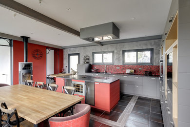 Design ideas for a large industrial l-shaped open plan kitchen in Nancy with a submerged sink, grey cabinets, granite worktops, red splashback, ceramic splashback, integrated appliances, ceramic flooring, an island, multi-coloured floors and grey worktops.