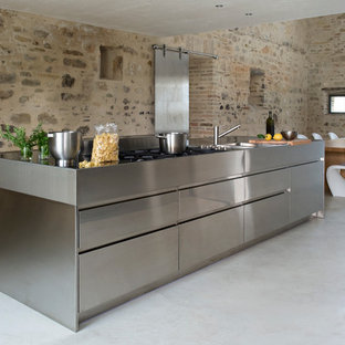 Photo of a medium sized contemporary single-wall kitchen/diner in Other with stainless steel cabinets and an island.