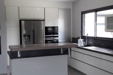 This is an example of a large modern kitchen in Other.