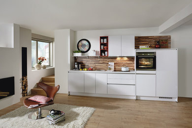 Imagen de cocina lineal escandinava de tamaño medio abierta sin isla con puertas de armario blancas y salpicadero marrón