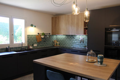 Large contemporary u-shaped open plan kitchen in Other with an integrated sink, beaded cabinets, black cabinets, wood worktops, ceramic splashback, black appliances, ceramic flooring, an island and grey floors.
