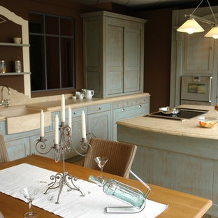 Design ideas for a mid-sized country open plan kitchen in Montpellier with a farmhouse sink, limestone benchtops, limestone splashback, marble floors, beige floor, yellow splashback, stainless steel appliances, with island and yellow benchtop.