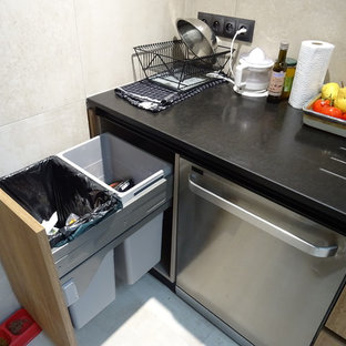 This is an example of a mid-sized tropical l-shaped eat-in kitchen in Marseille with an integrated sink, beaded inset cabinets, brown cabinets, granite benchtops, beige splashback, ceramic splashback, stainless steel appliances, ceramic floors, with island, beige floor and black benchtop.