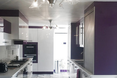 Design ideas for a large contemporary single-wall enclosed kitchen in Nice with a submerged sink, flat-panel cabinets, white cabinets, white splashback, ceramic splashback, stainless steel appliances, ceramic flooring and white worktops.