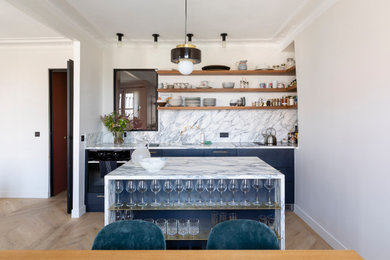 Medium sized contemporary single-wall open plan kitchen in Paris with a single-bowl sink, flat-panel cabinets, blue cabinets, marble worktops, marble splashback, integrated appliances, light hardwood flooring and an island.