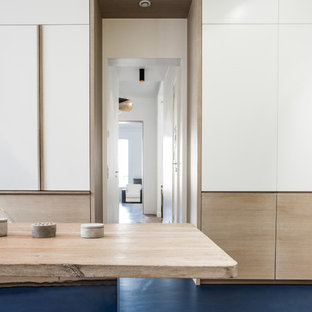 Design ideas for a large contemporary u-shaped kitchen in Paris with an integrated sink, marble benchtops, white splashback, marble splashback, panelled appliances, concrete floors, blue floor and white benchtop.