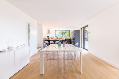Foto di una sala da pranzo aperta verso il soggiorno contemporanea di medie dimensioni con parquet chiaro e pavimento marrone