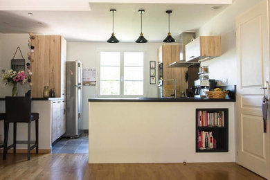 Réalisation d'une cuisine minimaliste de taille moyenne avec un évier 1 bac, un plan de travail en stratifié, une crédence noire, un sol gris et plan de travail noir.
