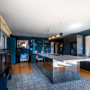 Design ideas for a mid-sized contemporary galley open plan kitchen in Marseille with an integrated sink, glass-front cabinets, black cabinets, terrazzo benchtops, black appliances, cement tiles, with island, blue floor and blue benchtop.