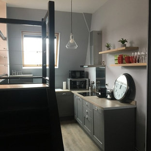 Photo of a small contemporary l-shaped open plan kitchen in Lille with an undermount sink, grey cabinets, laminate benchtops, stainless steel appliances, laminate floors, no island, beige floor and beige benchtop.