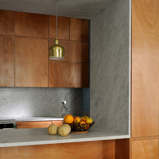 Small midcentury galley open plan kitchen in Lyon with an integrated sink, beaded inset cabinets, dark wood cabinets, marble benchtops, white splashback, stone slab splashback, dark hardwood floors and multiple islands.