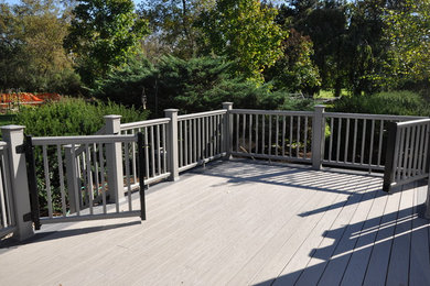 Inspiration for a huge timeless backyard deck remodel in Chicago with a roof extension