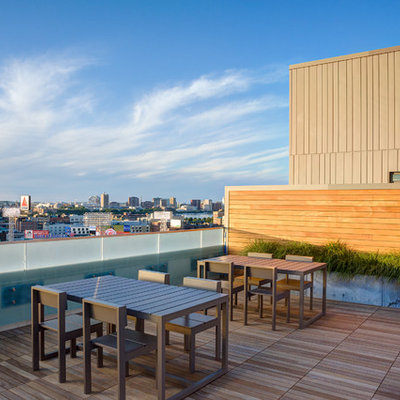 Large trendy rooftop deck container garden photo in Boston with no cover