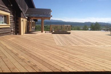 Inspiration for a huge craftsman backyard deck remodel in Other with no cover