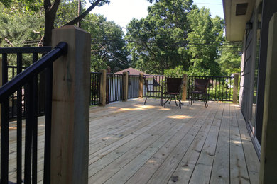 Example of a mid-sized transitional backyard deck design in Kansas City
