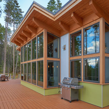 A cedar deck runs the length of the window wall.