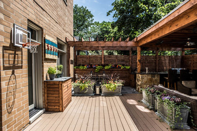 Example of a mid-sized rooftop outdoor kitchen deck design in Chicago with a pergola