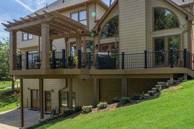 Mid-sized transitional backyard deck photo in Atlanta with a pergola