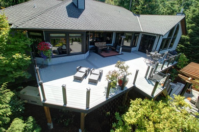 Outdoor kitchen deck - large contemporary backyard outdoor kitchen deck idea in Seattle with a pergola