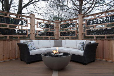 Mid-sized elegant backyard deck photo in Toronto with a fire pit and a pergola