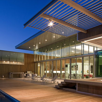 Huge trendy deck photo in Omaha with a pergola
