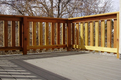 Example of a large arts and crafts backyard deck design in Salt Lake City with an awning