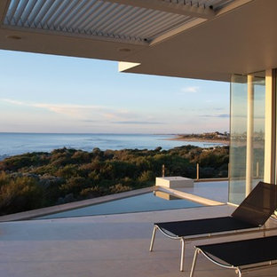 This is an example of a modern deck in Perth with a roof extension.
