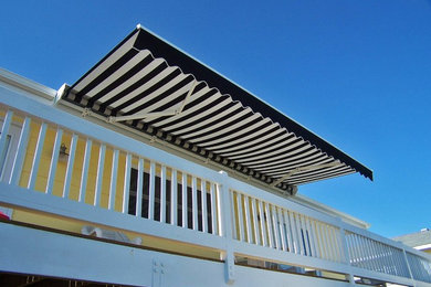 Deck - coastal backyard deck idea in Other with an awning