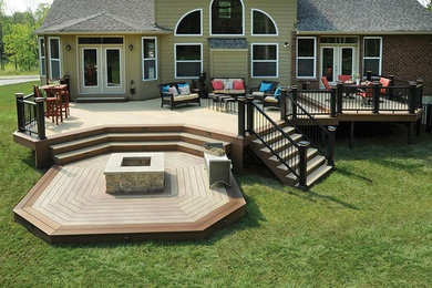 Inspiration for a large modern backyard deck remodel in Boston with a fire pit and no cover
