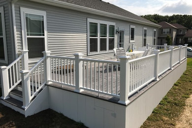 Example of a transitional backyard deck design in Milwaukee