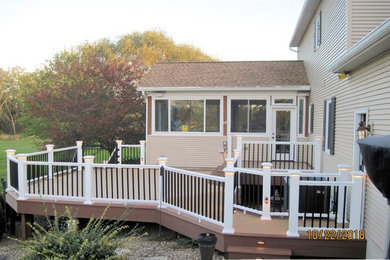 Example of a large minimalist backyard deck design in Other