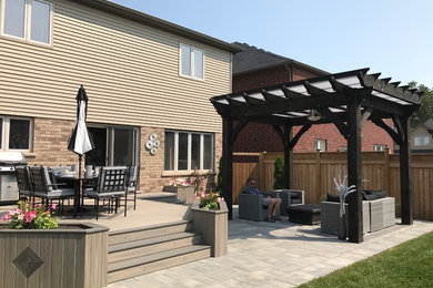 Deck - mid-sized craftsman deck idea in Other with a pergola