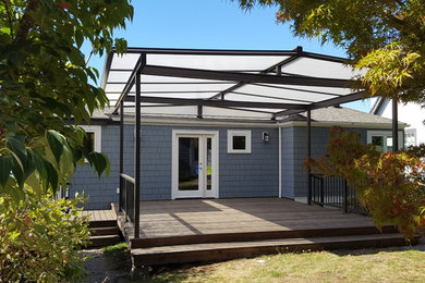 Medium sized classic back terrace in Seattle with a pergola.