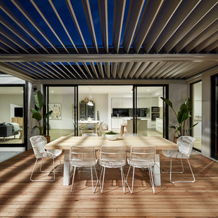 Photo of a contemporary backyard deck in Melbourne with a pergola.