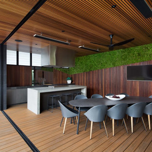 Design ideas for a contemporary deck in Melbourne with an outdoor kitchen and a roof extension.