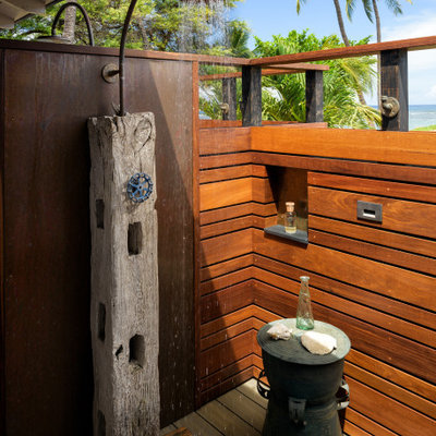 Example of a small beach style backyard outdoor shower deck design in Hawaii with a roof extension
