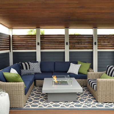 Inspiration for a large coastal backyard deck remodel in Chicago with a fire pit and a roof extension