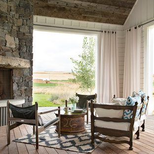 Deck - mid-sized farmhouse side yard deck idea in Other with a fire pit and a roof extension