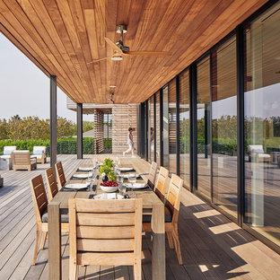 Deck - huge coastal deck idea in New York with a roof extension