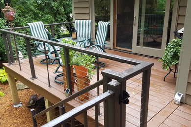 Example of a mid-sized classic backyard deck design in Minneapolis with no cover