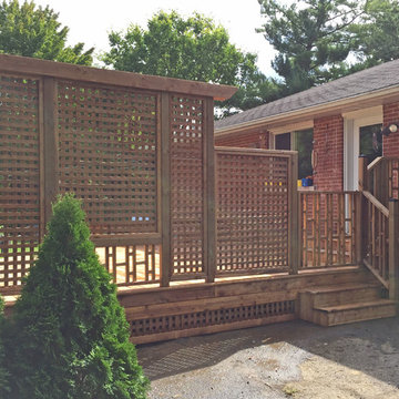 Brown Treated Wood Deck with Custom Privacy Wall and Custom Bench