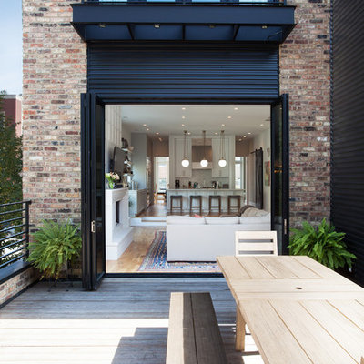 Mid-sized minimalist rooftop deck photo in Chicago with a roof extension
