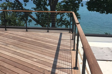 Example of a large transitional backyard deck design in Chicago with no cover