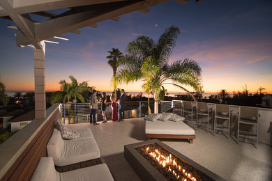 Inspiration for a mid-sized modern rooftop deck remodel in San Diego with a fire pit and a pergola