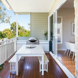 Inspiration for a contemporary deck in Brisbane with an outdoor kitchen and a roof extension.