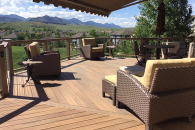 Large trendy backyard deck photo in Denver with an awning